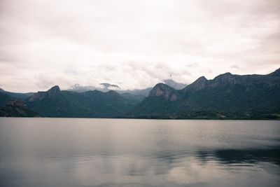 Scenic view of calm sea against cloudy sky