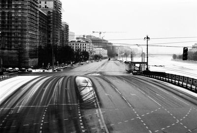 Railroad tracks in city against clear sky