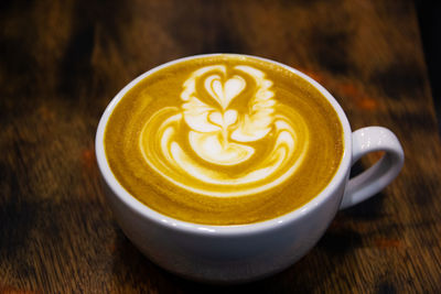 Close-up of cappuccino served on table