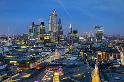 High angle view of illuminated city buildings against sky