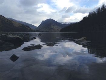 Scenic view of lake and mountains against sky