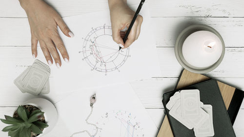 Cropped hands of woman using digital tablet