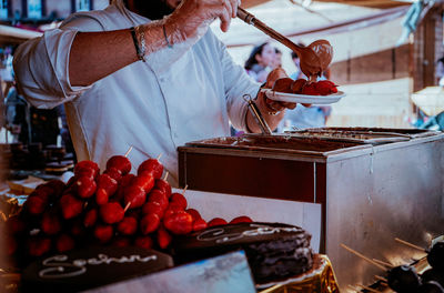 Midsection of man preparing food