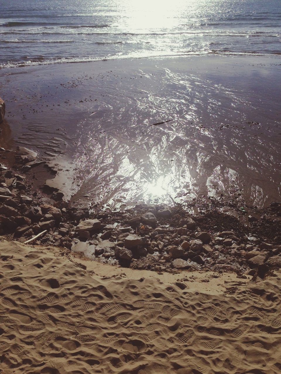 water, beach, sand, tranquility, sunlight, nature, reflection, wet, puddle, shore, beauty in nature, tranquil scene, outdoors, no people, scenics, sun, day, high angle view, rippled, weather