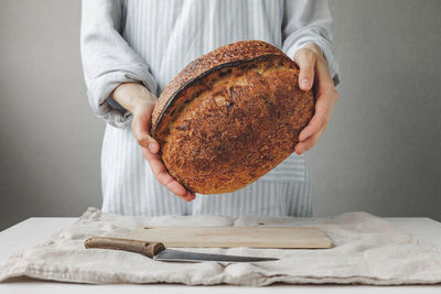 Midsection of woman holding food on table