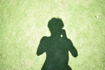 Shadow of man on golf course