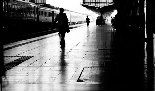 People walking on railroad station platform