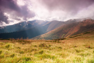 Scenic view of landscape and mountains against sky