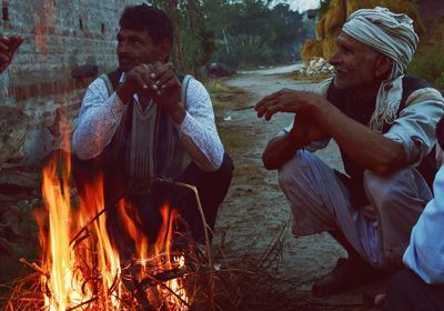 People sitting on bonfire