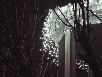 Low angle view of illuminated lights at night