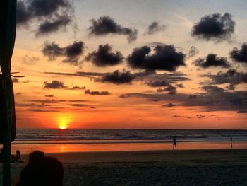 Scenic view of beach against sky during sunset