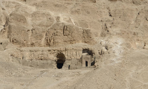 Rear view of people walking on rock