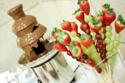 Close-up of fruits and chocolate fountain on table