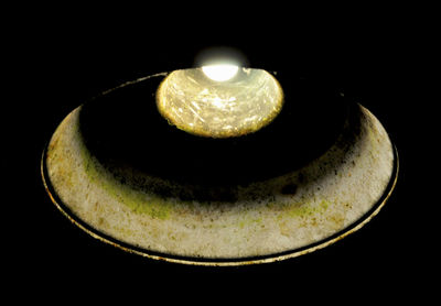 Close-up of illuminated lamp against black background