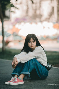 Portrait of woman sitting in city
