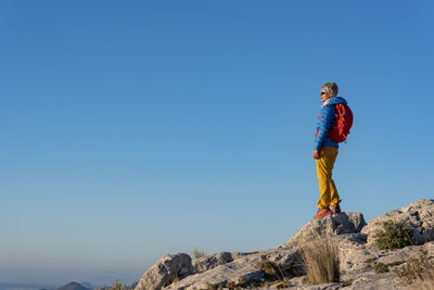 A woman hiking in the high country, el divino mountain, costa blanca