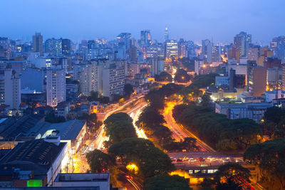 Illuminated cityscape against sky at night