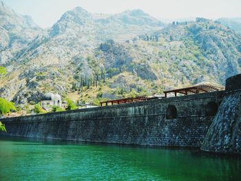 View of calm countryside lake against mountain range