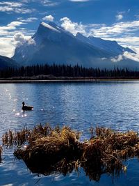Scenic view of lake against sky during winter