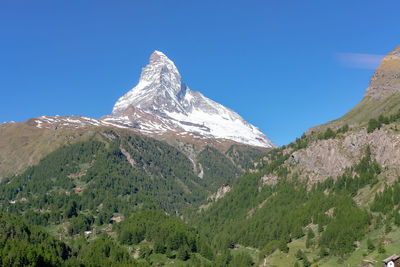 Scenic view of mountains against clear blue sky