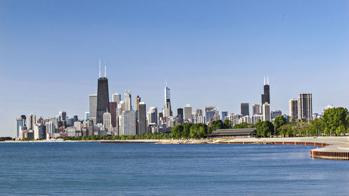 View of buildings in city against clear sky