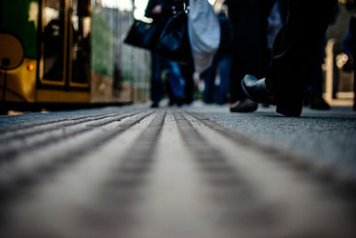 Surface level of man walking by tramway