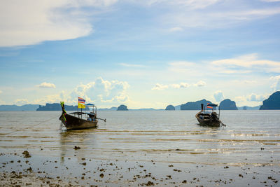 Fishing boat on sea against sky