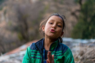 Portrait of boy standing on land