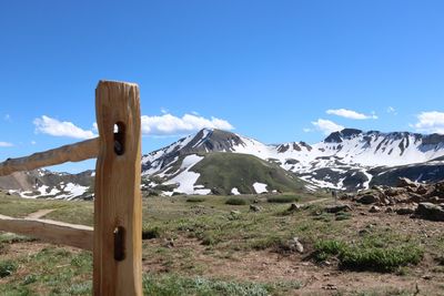 Scenic view of snowcapped mountains against blue sky