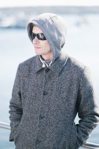 Man wearing hooded shirt standing outdoors