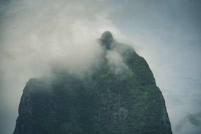 Low angle view of rock formations against sky