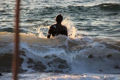 Rear view of man on sea shore