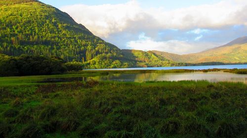 Scenic view of lake and mountains against sky