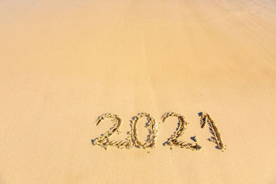 High angle view of text written on sand at beach