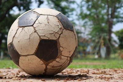 Close-up of old ball on field