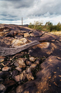 Rock formations against cloudy sky