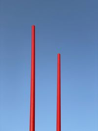 Low angle view of red structure against blue sky