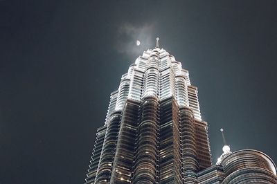 Low angle view of modern building against sky at night