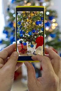 Close-up of hand holding mobile phone