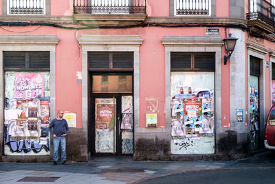 People standing on street by building