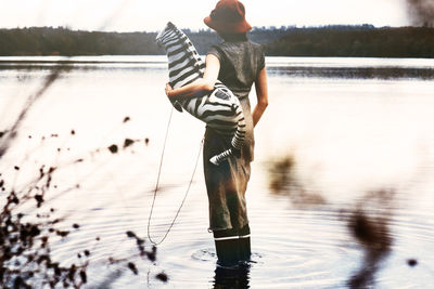 Full length of man standing on lake against sky