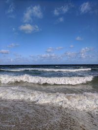 Scenic view of sea against cloudy sky