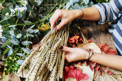 Midsection of woman holding corn