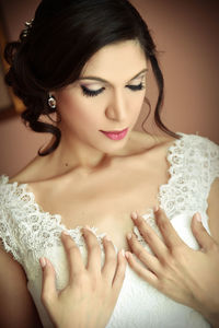 Close-up of bride with hands on chest