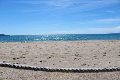 Scenic view of beach against blue sky