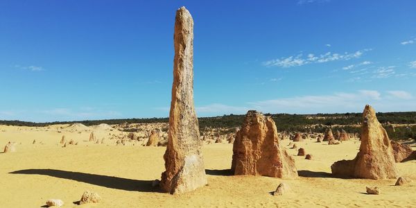 Traditional windmill on desert against sky