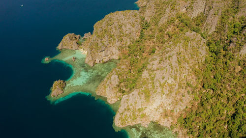 Blue lagoons and cliffs of tropical mountain island. aerial view seascape, tropical landscape. 