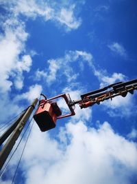 Low angle view of crane against sky