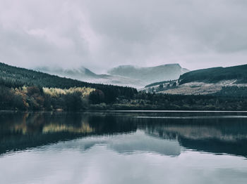 Scenic view of lake and mountains against sky