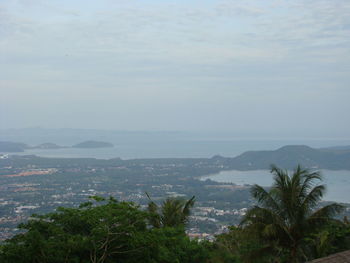 Scenic view of sea and mountains against sky